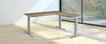 standing corner desk in an empty room with big glass doors
