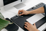 magnetic cable holder being used on a black desk mat
