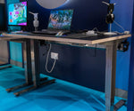 steel standing desk with gaming setup