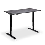 a modern, minimalist standing desk with a sleek, black metal frame and a dark-colored wooden top.