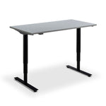 a simple standing desk with a grey top surface and black metal legs.