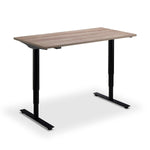 A simple, rectangular walnut standing desk with black metal legs.