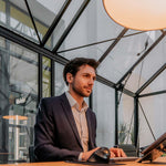 Man working with Bakker Elkhuizen Ergo-Q 160 Laptop Stand 