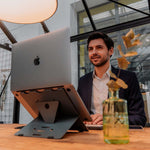 Man working on Bakker Elkhuizen Ergo-Q 160 Laptop Stand 