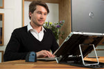 Man working with laptop on adjustable Bakker Elkhuizen Ergo-Q 330 Laptop Stand.