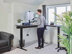 Man using Bakker Elkhuizen Filex Galaxy Single Monitor Arm at standing desk.