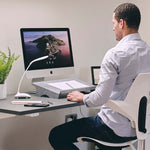 Man sat at his desk using the bakker elkhuizen document holder.