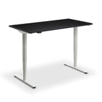 a modern, adjustable standing desk with a sleek black top and white legs.