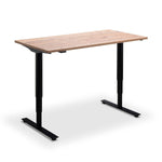 A simple, rectangular wooden desk with a black metal frame.