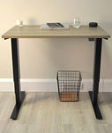 Mini sit stand desk with items on top.