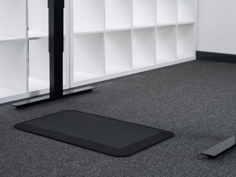 black standing desk floor mat on the floor 