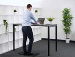 man working at 4 legged standing desk